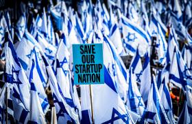 Protesters wave flags and placards in front of the Knesset to demonstrate their opposition to judicial reforms proposed by the coalition government of Israeli Prime Minister Netanyahu - source: Reuters