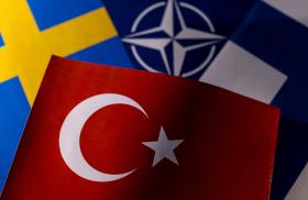 Photo illustration of the flags of Sweden, NATO, Finland, and Turkey - source: Reuters